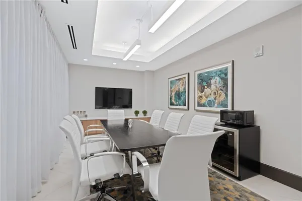 a view of a dining room with furniture and a flat screen tv