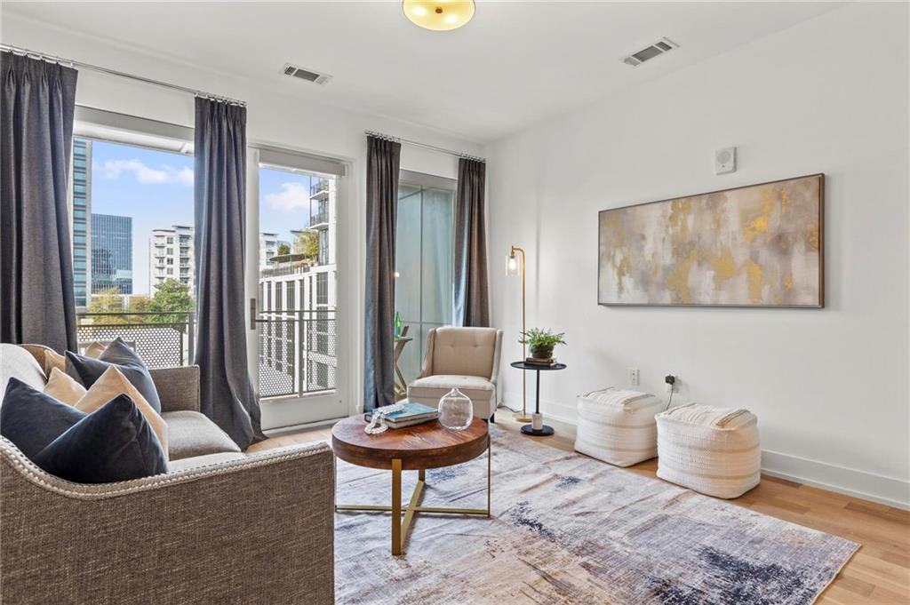 775 Juniper Street Northeast, Unit 613 Atlanta, GA 30308 - Photo 7 of 39 a living room with furniture and a window