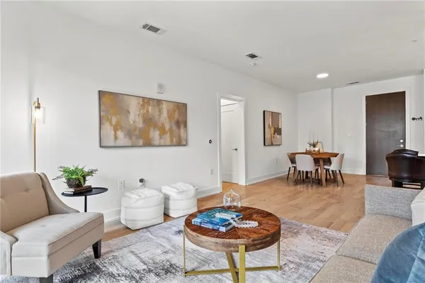 a living room with furniture a rug and a table