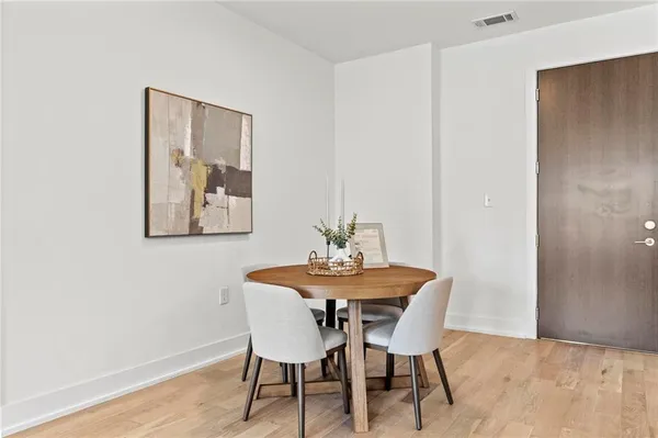 a view of a dining room with furniture and wooden floor