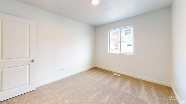 783 Pheasantbrook Drive, Unit 2A Centerville, UT 84014 - Photo 28 of 41 Neutral-toned room featuring a single window, recessed lighting, a paneled door, and light-colored carpeting