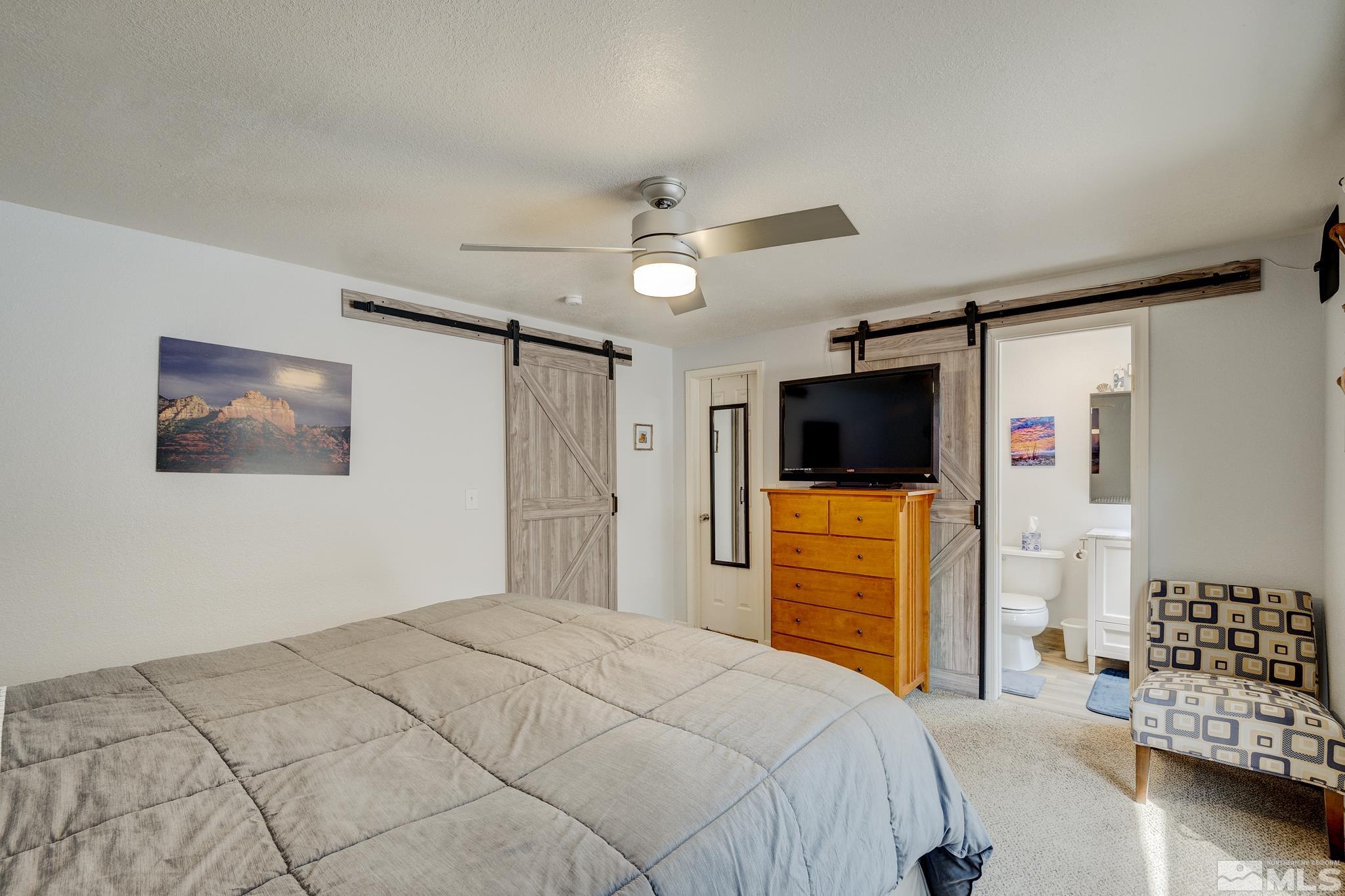 1000 Roberts Street Reno, NV 89502 - Photo 13 of 40 a bedroom with a bed and a flat screen tv