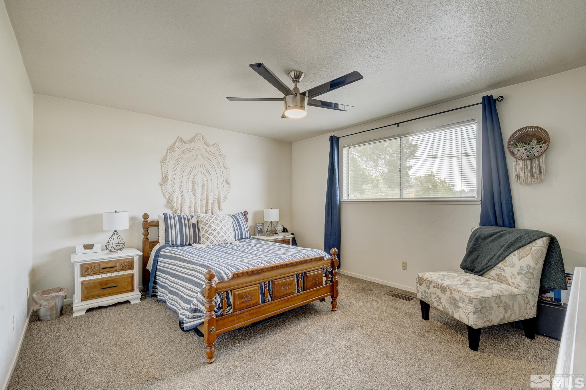 1000 Roberts Street Reno, NV 89502 - Photo 31 of 40 a bedroom with a bed and a chandelier