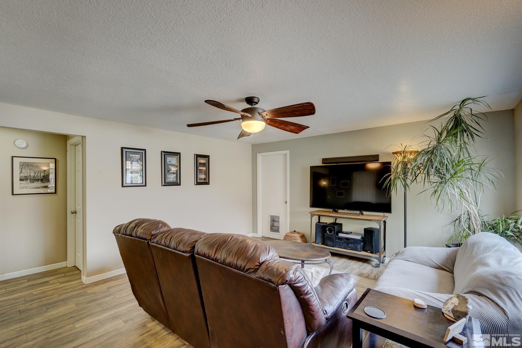 1000 Roberts Street Reno, NV 89502 - Photo 7 of 40 a living room with furniture a flat screen tv and a fireplace