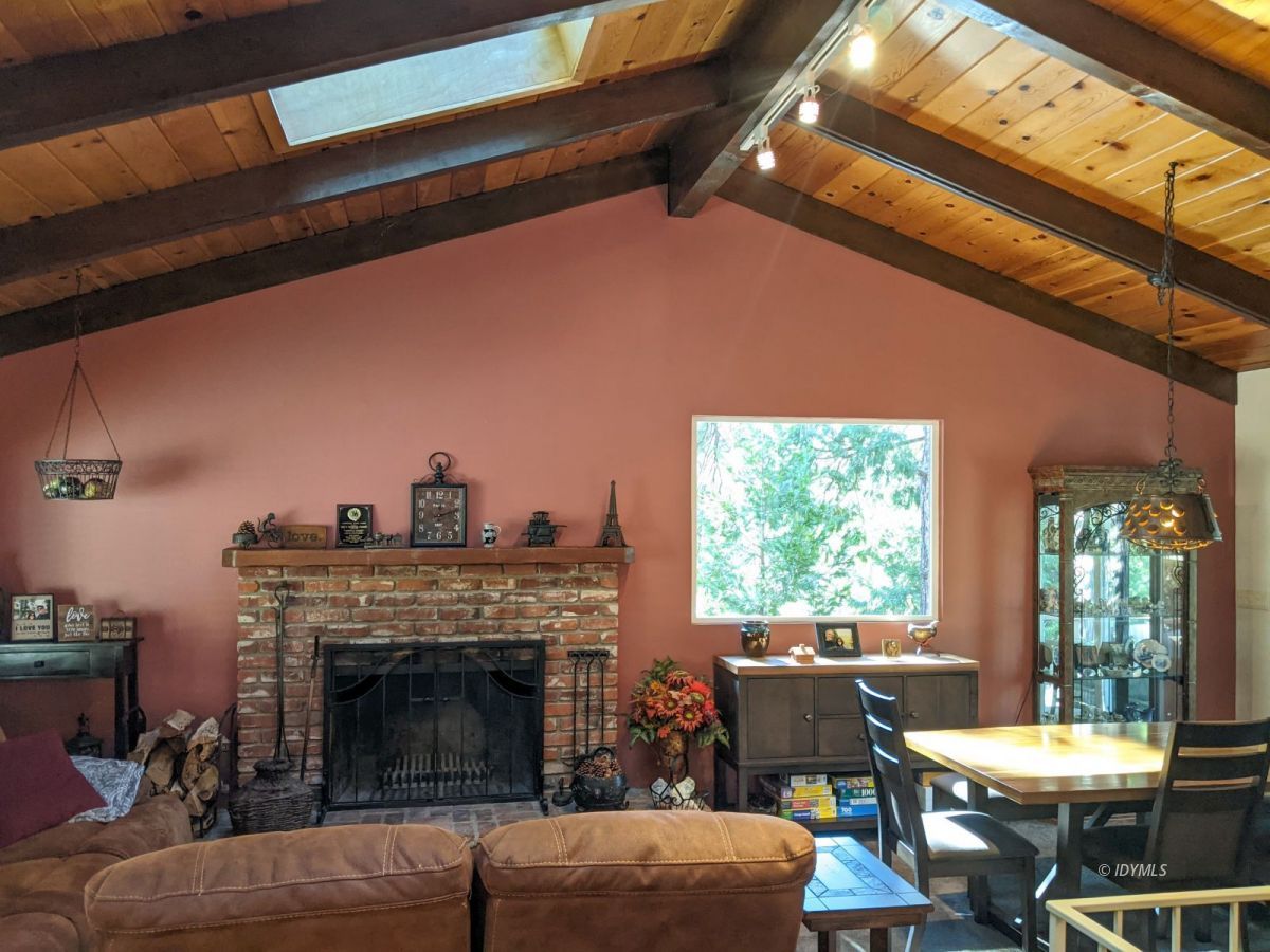 25915 Wayne Road Idyllwild, CA 92549 - Photo 11 of 69 a living room with furniture a window and a fireplace