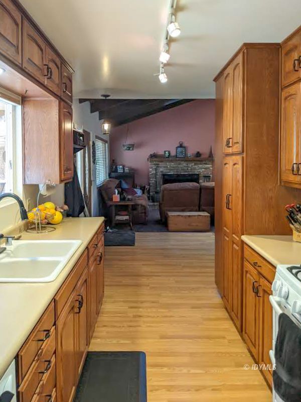 25915 Wayne Road Idyllwild, CA 92549 - Photo 17 of 69 a large kitchen with stainless steel appliances a stove a refrigerator a sink and dishwasher with wooden floor