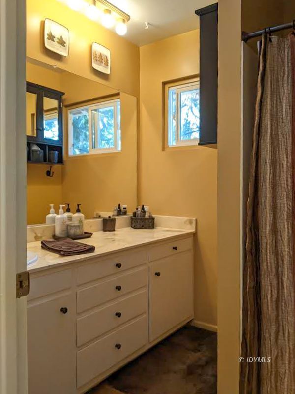 25915 Wayne Road Idyllwild, CA 92549 - Photo 33 of 69 a bathroom with a double vanity sink and a mirror