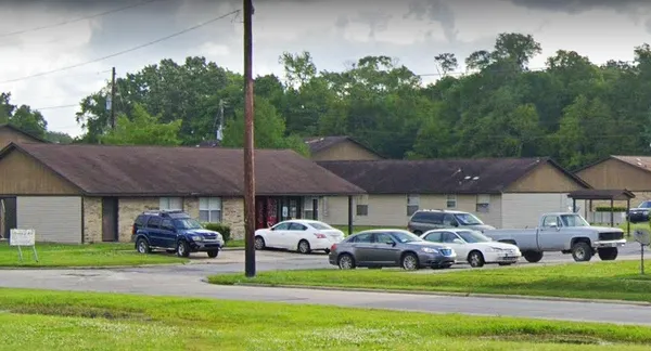 a front view of a residential houses with yard and outdoor seating