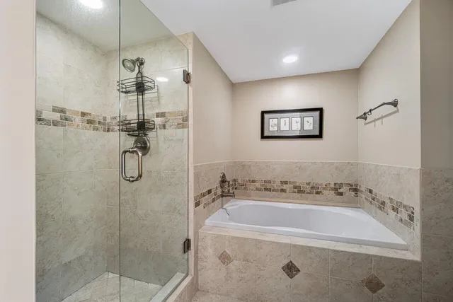 a spacious bathroom with a bathtub and a shower