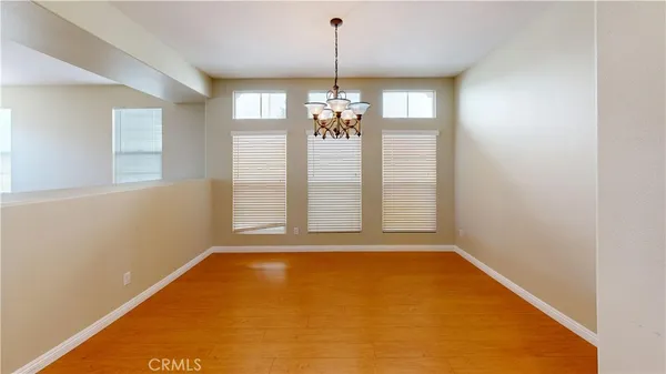 a view of a room with window chandelier chandeliers