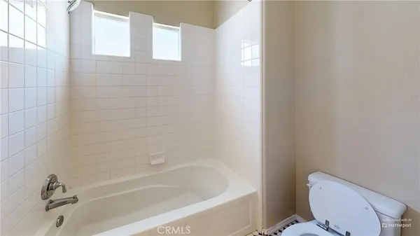 a white bath tub sitting next to a toilet