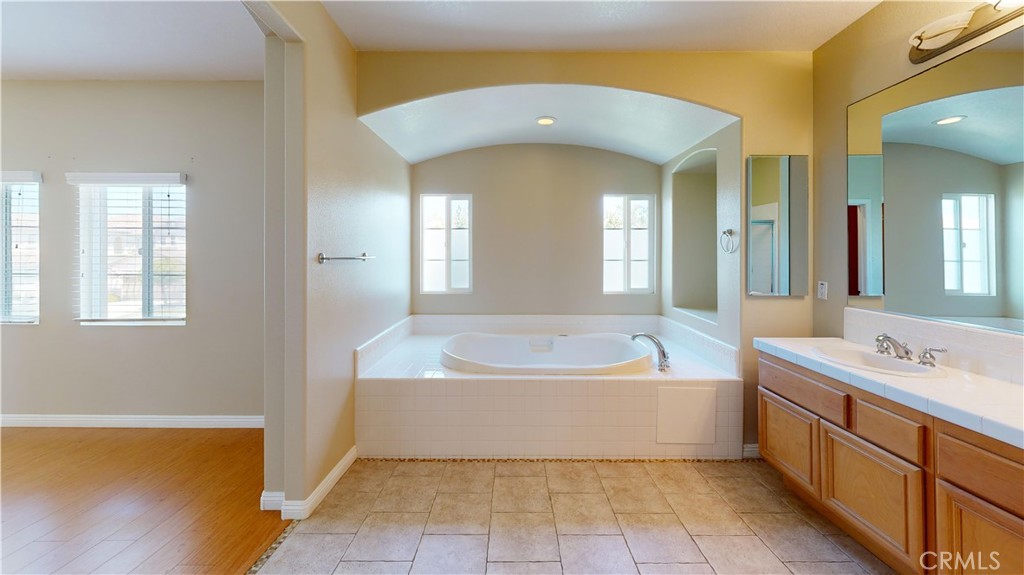 4312 Waterside Lane Oxnard, CA 93035 - Photo 20 of 23 a spacious bathroom with a tub a sink and a window