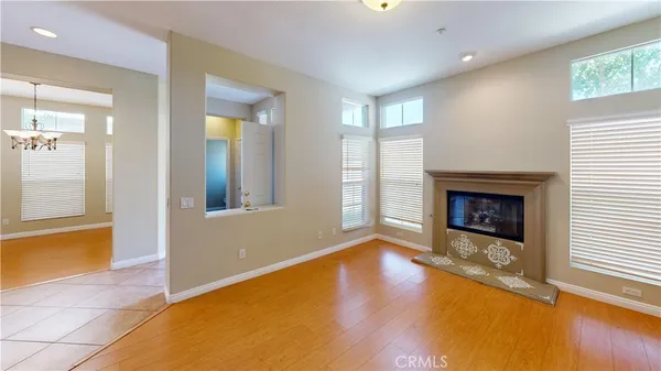 a view of an empty room with window and fire place