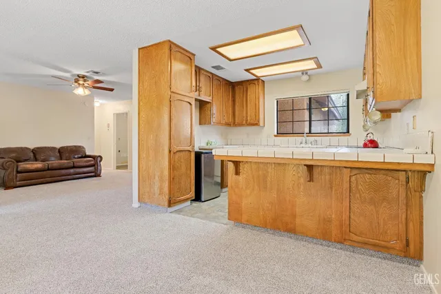 a kitchen with stainless steel appliances a sink and a refrigerator