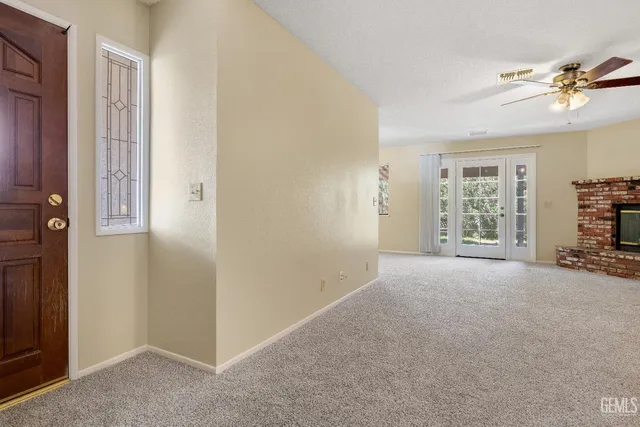 a view of a livingroom with a ceiling fan and window