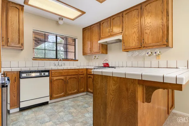 a kitchen with stainless steel appliances granite countertop a sink and cabinets