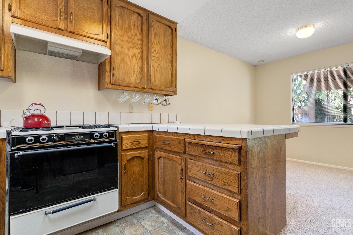 Undisclosed Address Ridgecrest, CA 93555 - Photo 10 of 25 a kitchen with stainless steel appliances granite countertop a stove and a microwave