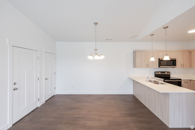 693 West 4500th South, Unit O302 Mapleton, UT 84664 - Photo 13 of 16 Kitchen featuring a peninsula, electric range, light wood finish cabinets, dark wood finished floors, and hanging lights