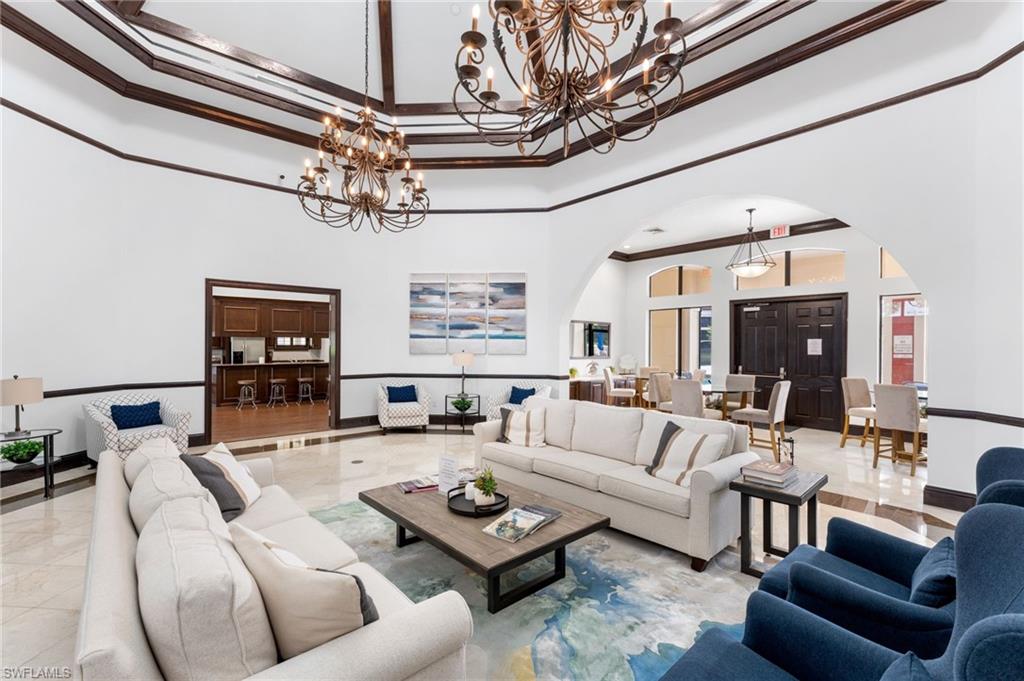 a living room with furniture a chandelier and a flat screen tv