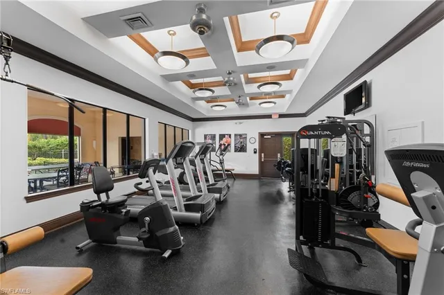 a room with gym equipment and a large window