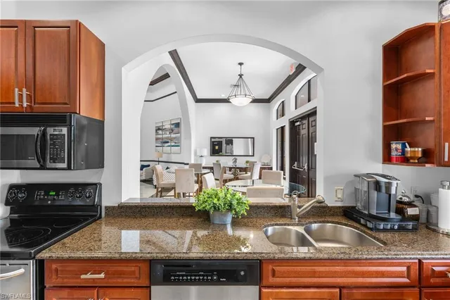 a kitchen with stainless steel appliances granite countertop a sink and cabinets