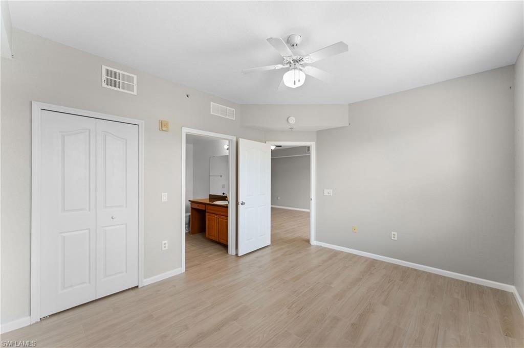 12920 Positano Circle, Unit 303 Naples, FL 34105 - Photo 7 of 21 wooden floor in an empty room