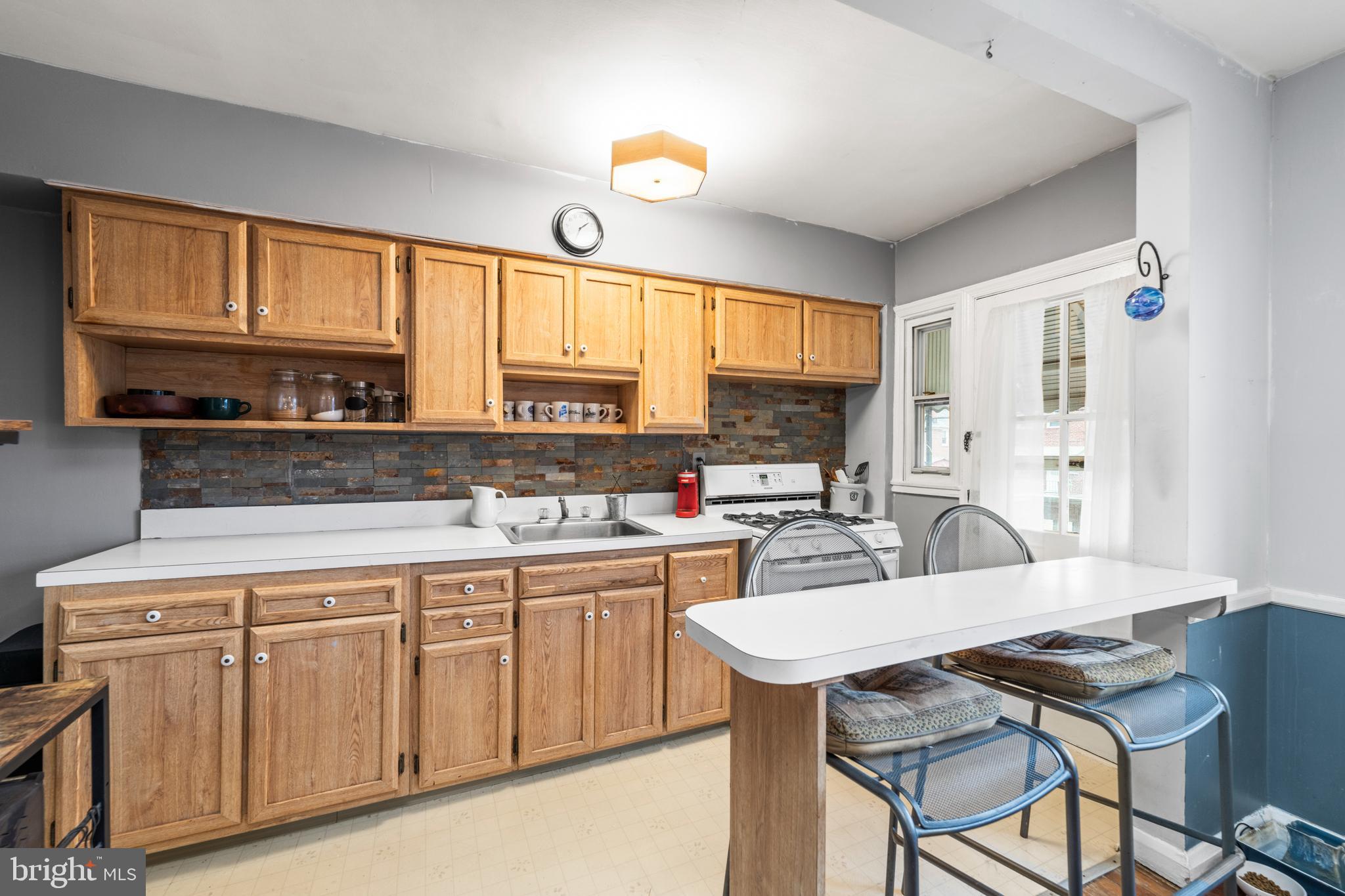 8352 Ridgely Oak Road Baltimore, MD 21234 - Photo 13 of 37 a kitchen with a stove a sink and cabinets