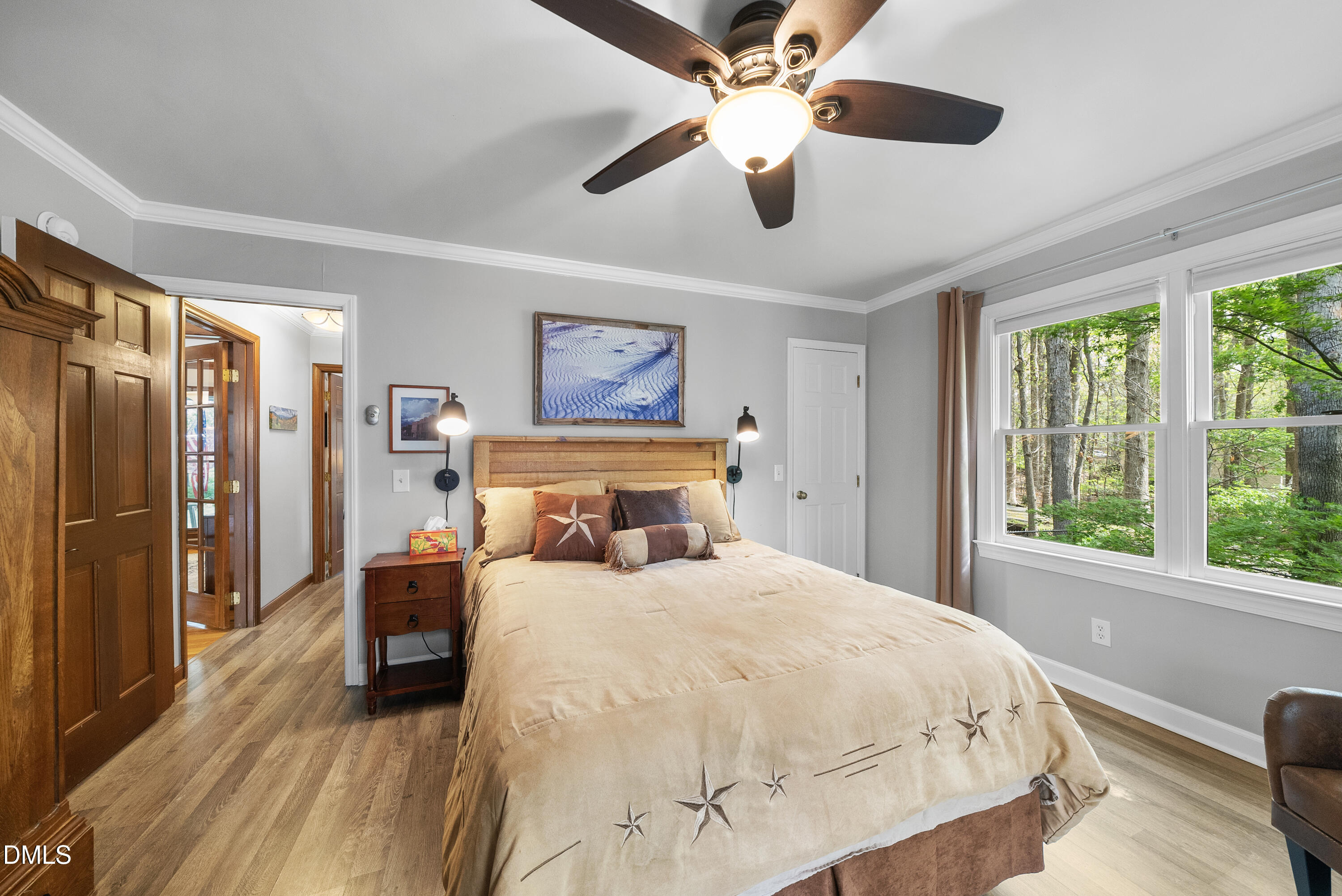 6200 Splitrock Trail Apex, NC 27539 - Photo 55 of 64 a bedroom with a large bed and a chandelier