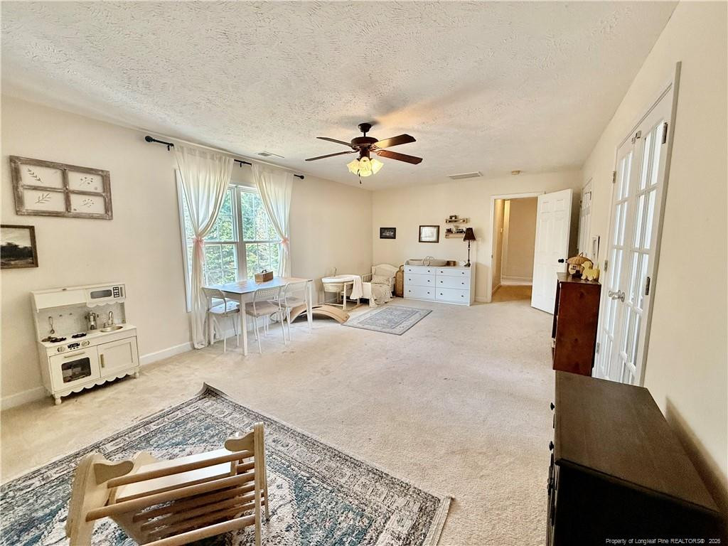 234 Pender Road Spring Lake, NC 28390 - Photo 24 of 39 a living room with furniture and a chandelier