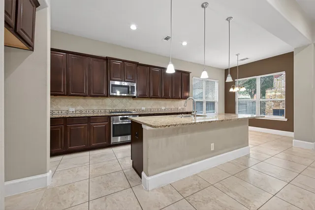 a large kitchen with a cabinets and a counter top space