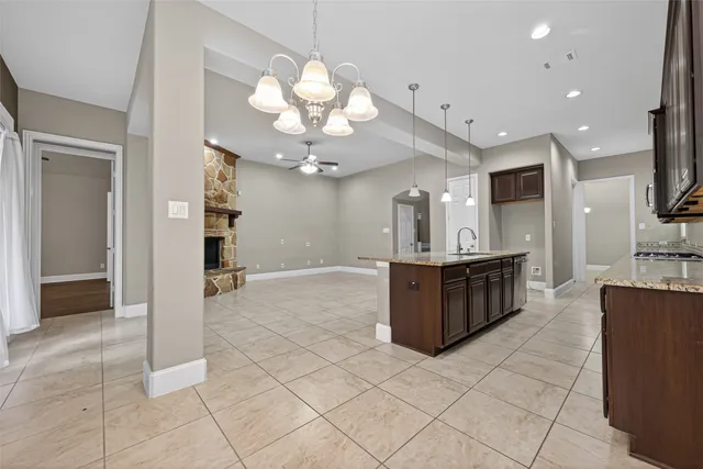 a kitchen with stainless steel appliances granite countertop a sink and a stove