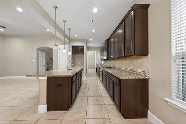 an empty room with windows and fireplace