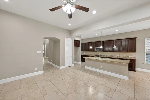 a large white kitchen with a stove a sink and a refrigerator