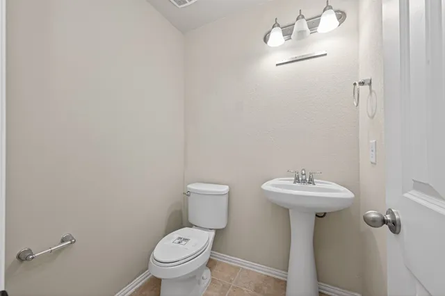 an empty room with closet and a chandelier fan