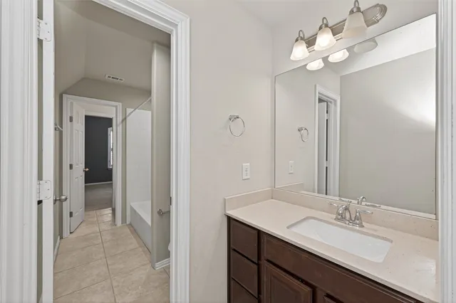 a bathroom with a sink vanity and a mirror
