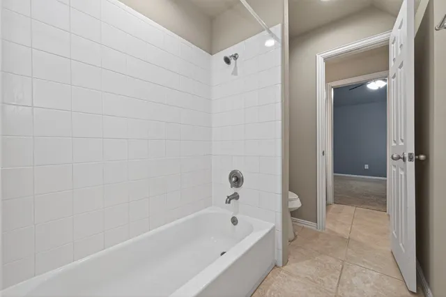 an empty room and chandelier fan