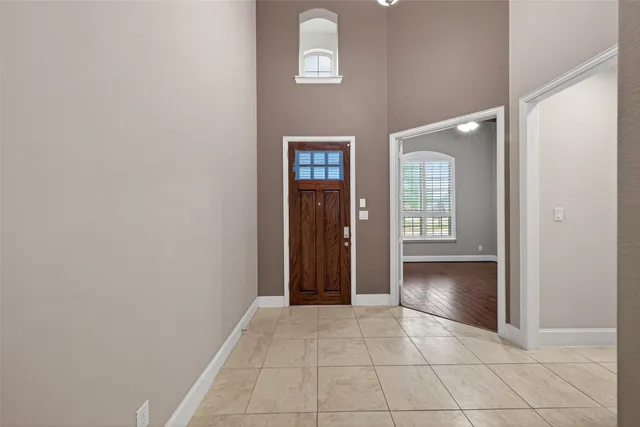 an empty room with entrance and windows