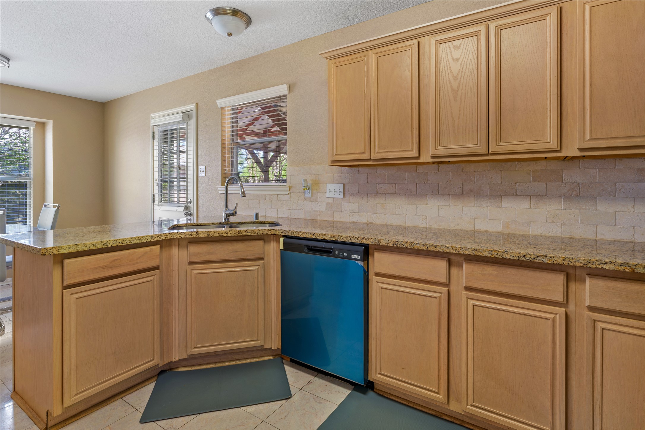 21074 Southern Colony Court Katy, TX 77449 - Photo 12 of 27 a kitchen with stainless steel appliances granite countertop white cabinets sink and dishwasher with wooden floor