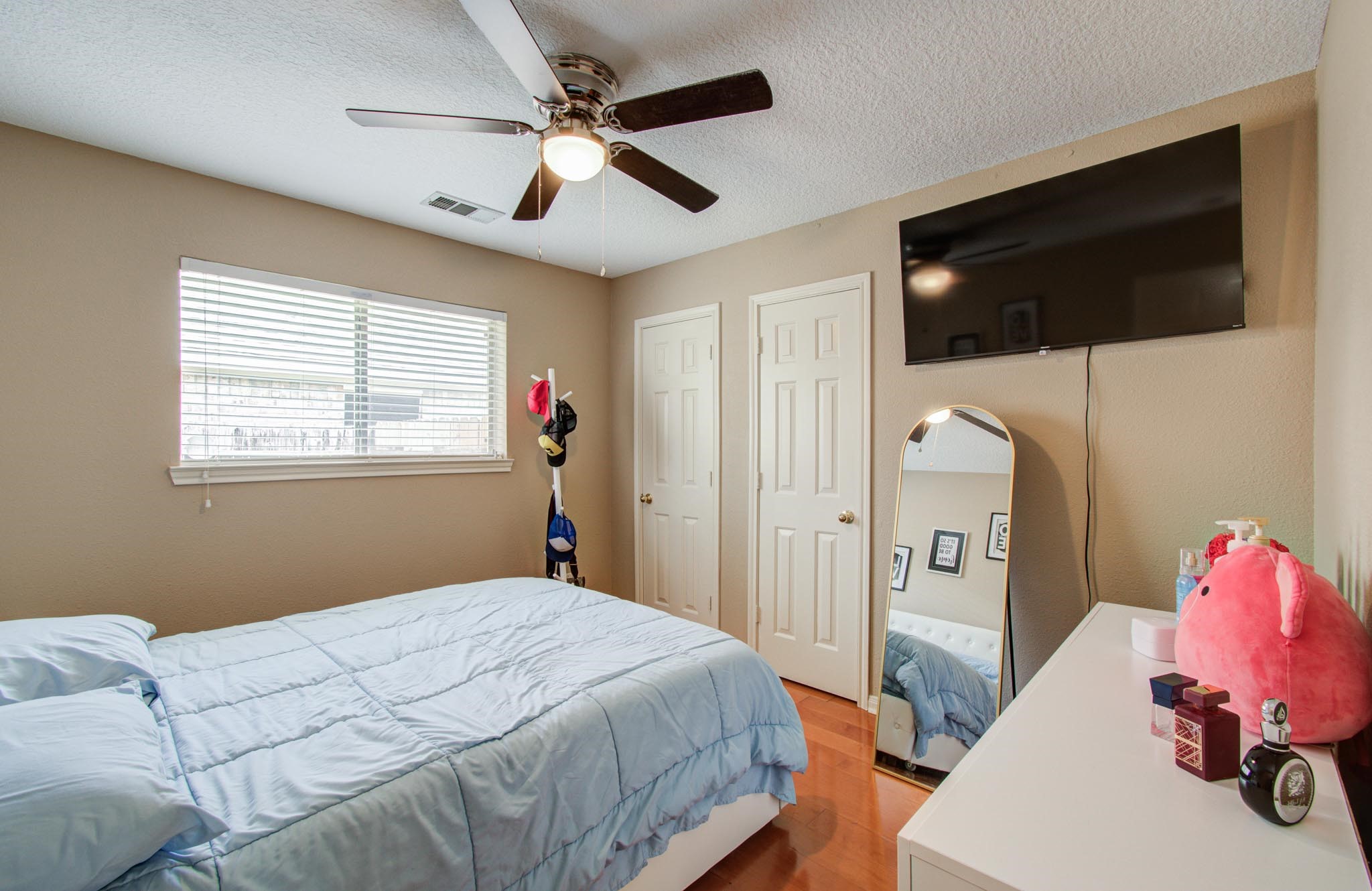 21074 Southern Colony Court Katy, TX 77449 - Photo 14 of 27 a bedroom with a bed a window and a flat screen tv