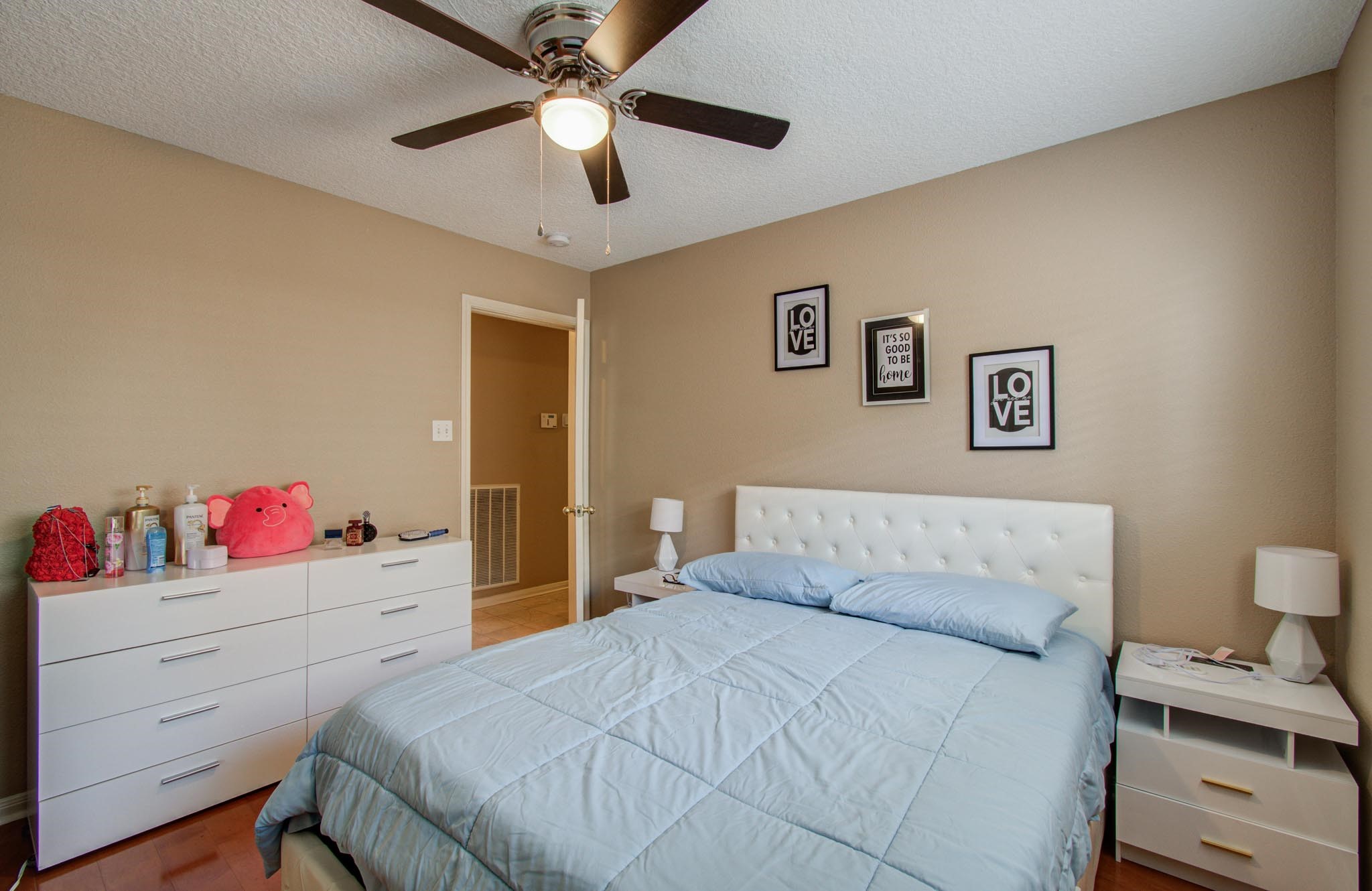 21074 Southern Colony Court Katy, TX 77449 - Photo 15 of 27 a bedroom with a bed and a chandelier
