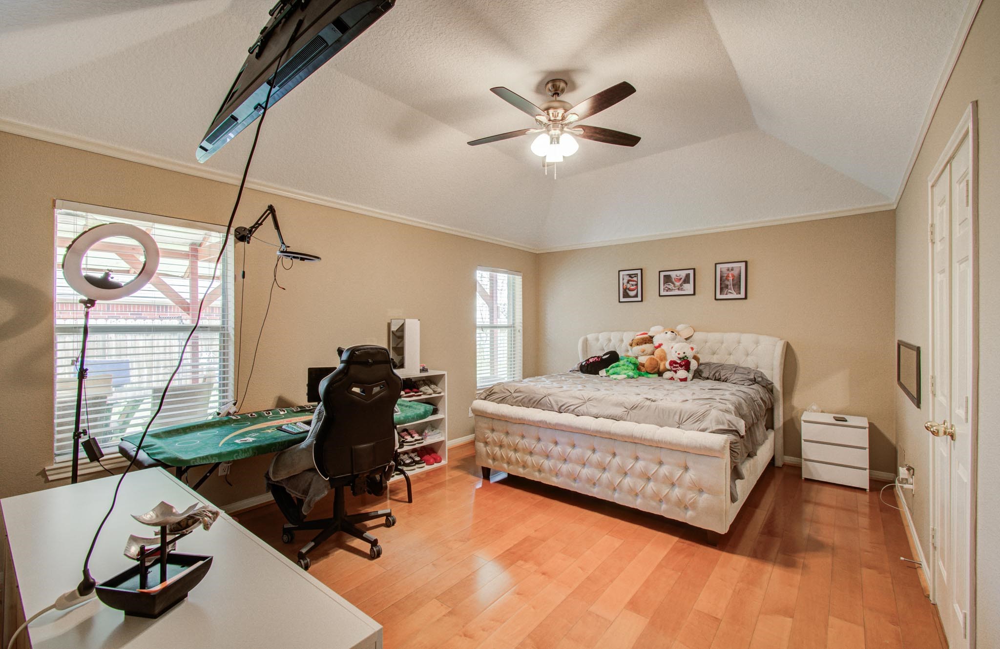 21074 Southern Colony Court Katy, TX 77449 - Photo 16 of 27 a bedroom with a bed and a chandelier