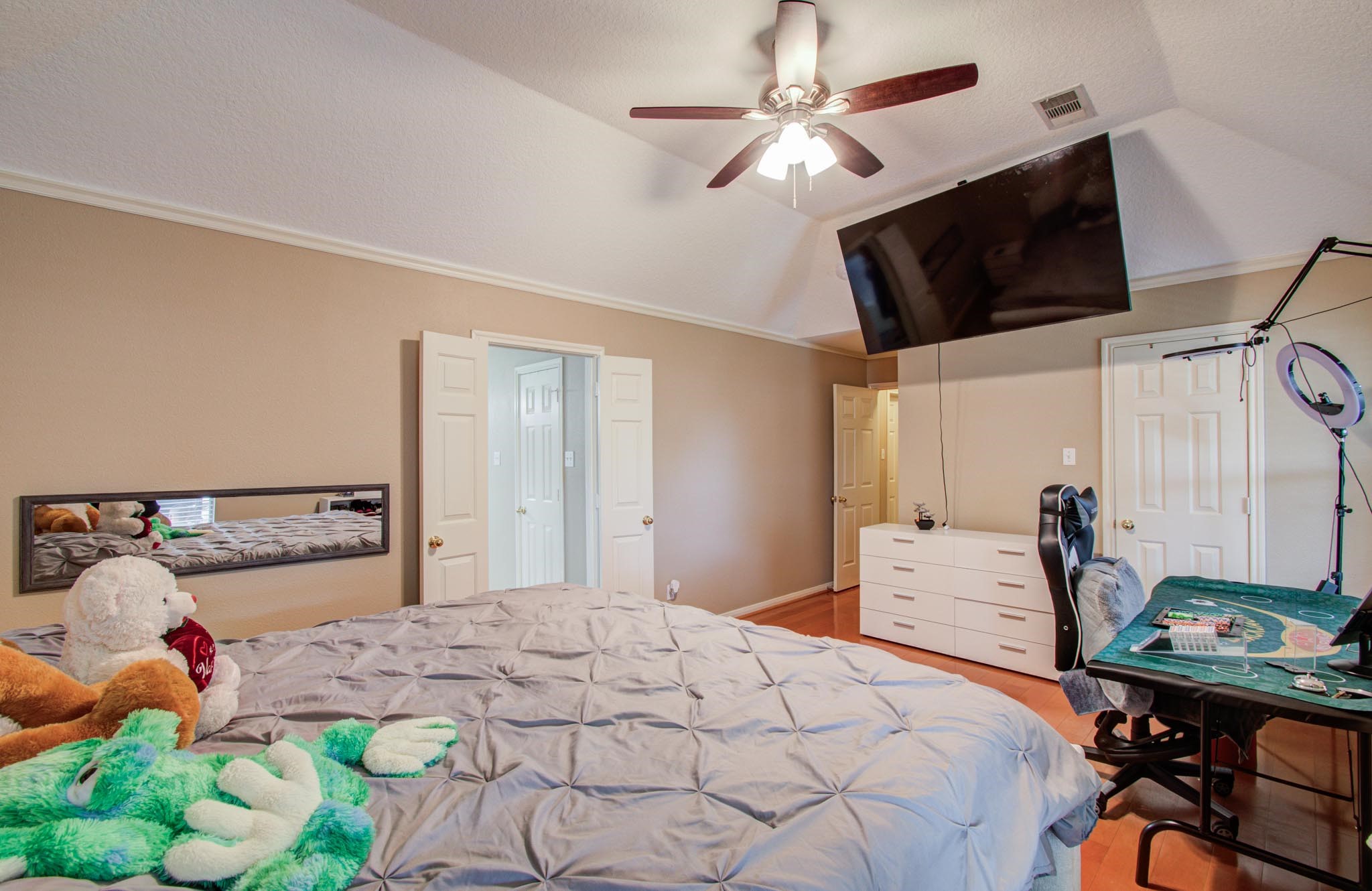 21074 Southern Colony Court Katy, TX 77449 - Photo 17 of 27 a bedroom with a bed a chandelier and closet