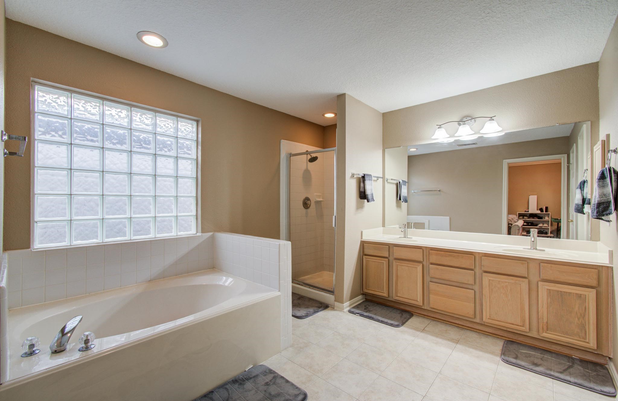 21074 Southern Colony Court Katy, TX 77449 - Photo 18 of 27 a spacious bathroom with a tub sink and mirror
