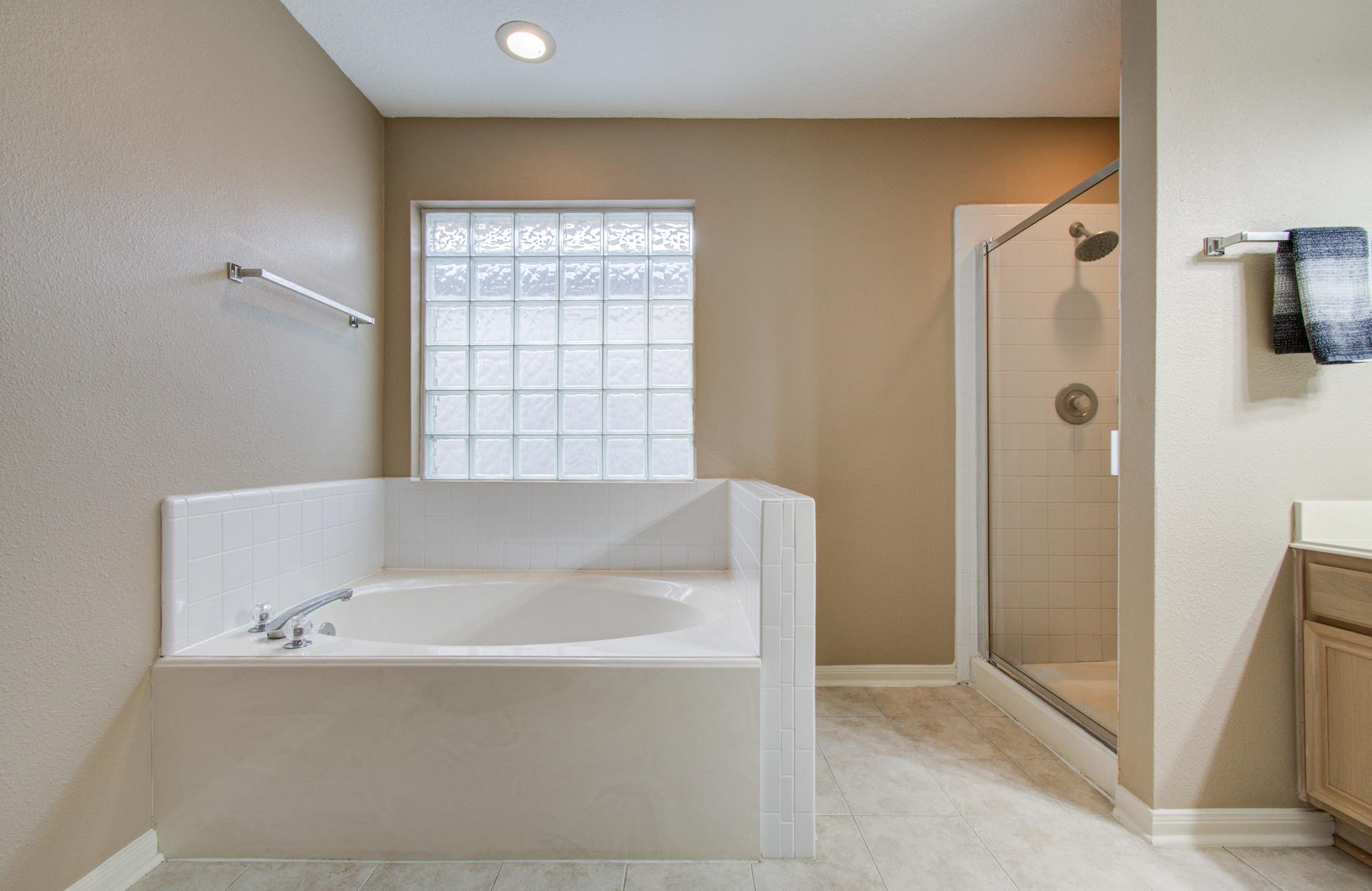 21074 Southern Colony Court Katy, TX 77449 - Photo 19 of 27 a bathroom with a bathtub and shower