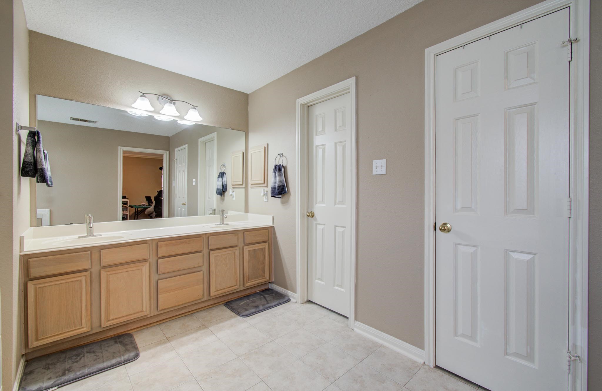 21074 Southern Colony Court Katy, TX 77449 - Photo 20 of 27 a spacious bathroom with a double vanity sink and a mirror