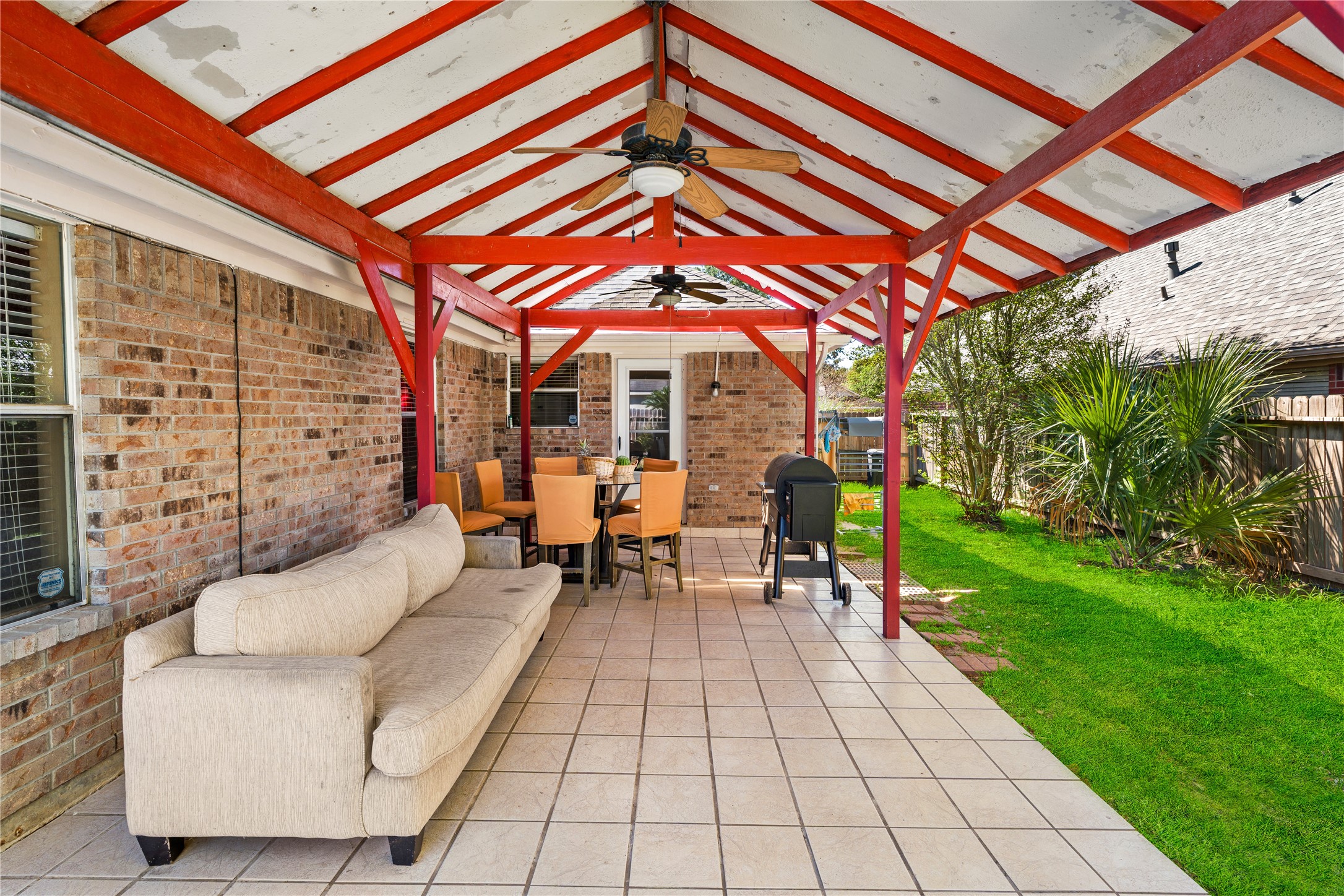 21074 Southern Colony Court Katy, TX 77449 - Photo 27 of 27 a view of a patio with a table and chairs under a large umbrella