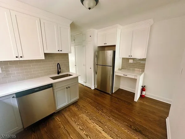 a kitchen with a refrigerator and cabinets
