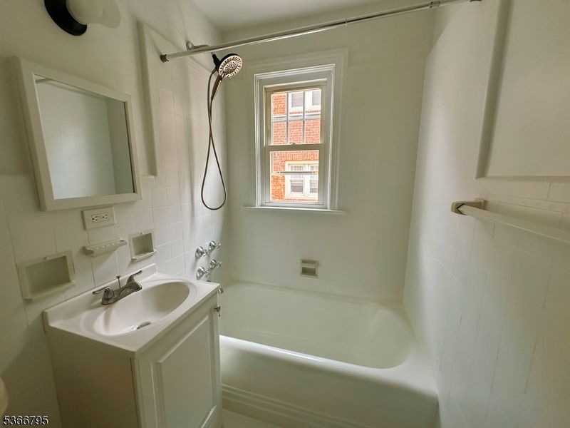 42 Center Street, Unit A Chatham, NJ 07928 - Photo 15 of 16 a bathroom with a sink vanity tub and shower