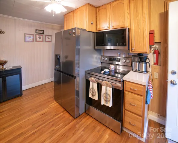 a kitchen with stainless steel appliances a stove and a refrigerator