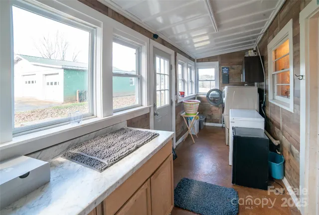 a living room with hard wood floor furniture and a floor to ceiling window